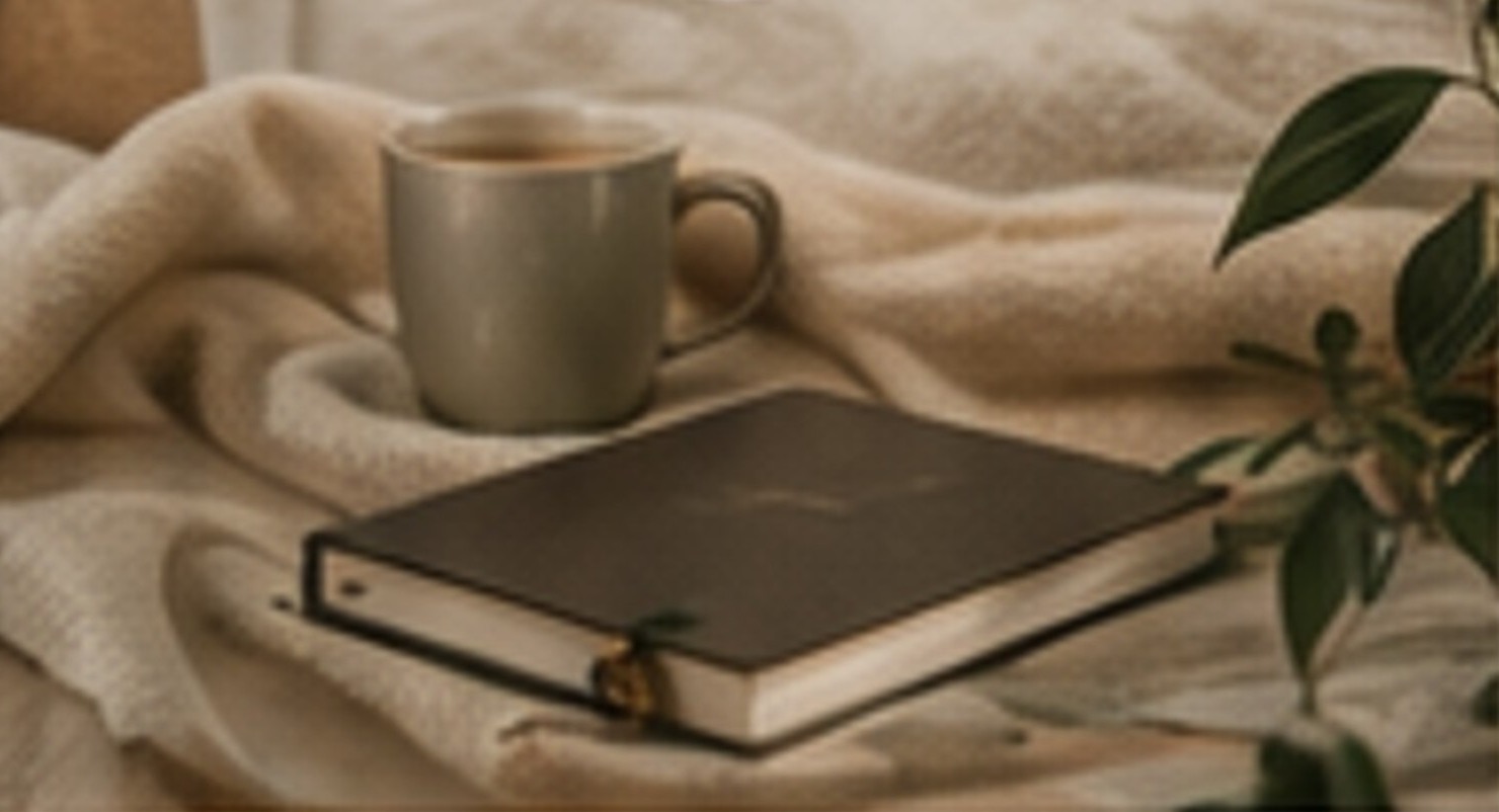 A peaceful mug and journal still life representing mercy.